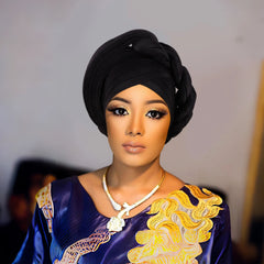 Woman wearing a raw silk pre-tied auto gele head wrap