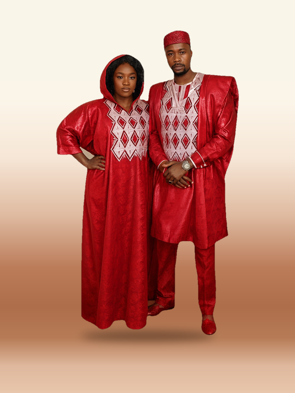 A couple wearing matching His & Hers Agbada Set – 3-Piece Bazin, photographed on the ARINZE studio backdrop