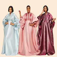 Metallic brocade boubou gown with dramatic bell sleeves, shown in sky blue, pink and purple