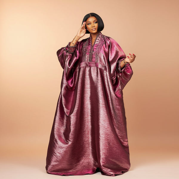 Purple metallic brocade boubou gown with bell sleeves and beaded neckline, worn by a model