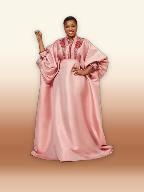Pink metallic brocade boubou gown with bell sleeves and beaded neckline, worn by a model