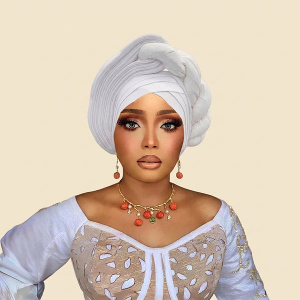 Woman wearing a raw silk pre-tied auto gele head wrap