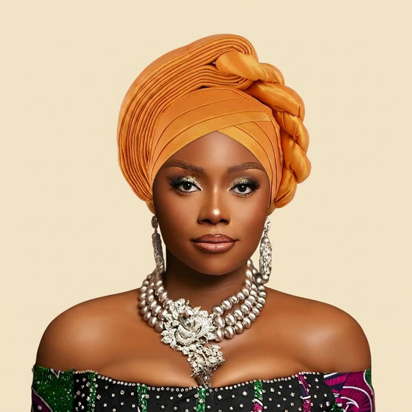 Woman wearing a raw silk pre-tied auto gele head wrap
