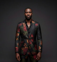 Man wearing a floral suit jacket against a dark background